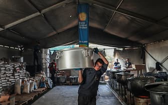 RAFAH, GAZA - FEBRUARY 21: Volunteers of World Central Kitchen cook food for more than 5.000 Palestinians, in the mobile kitchens they have brought to Rafah, Gaza on February 21, 2024. Thousands of Palestinians face the threat of famine due to ongoing Israeli blockade. (Photo by Jehad Alshrafi/Anadolu via Getty Images)