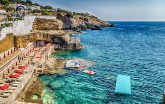 bathing facilities, rocks and architecture of the coast of Salento of the Ionian Sea in Italy, in Santa Cesarea Terme, Lecce, Apulia