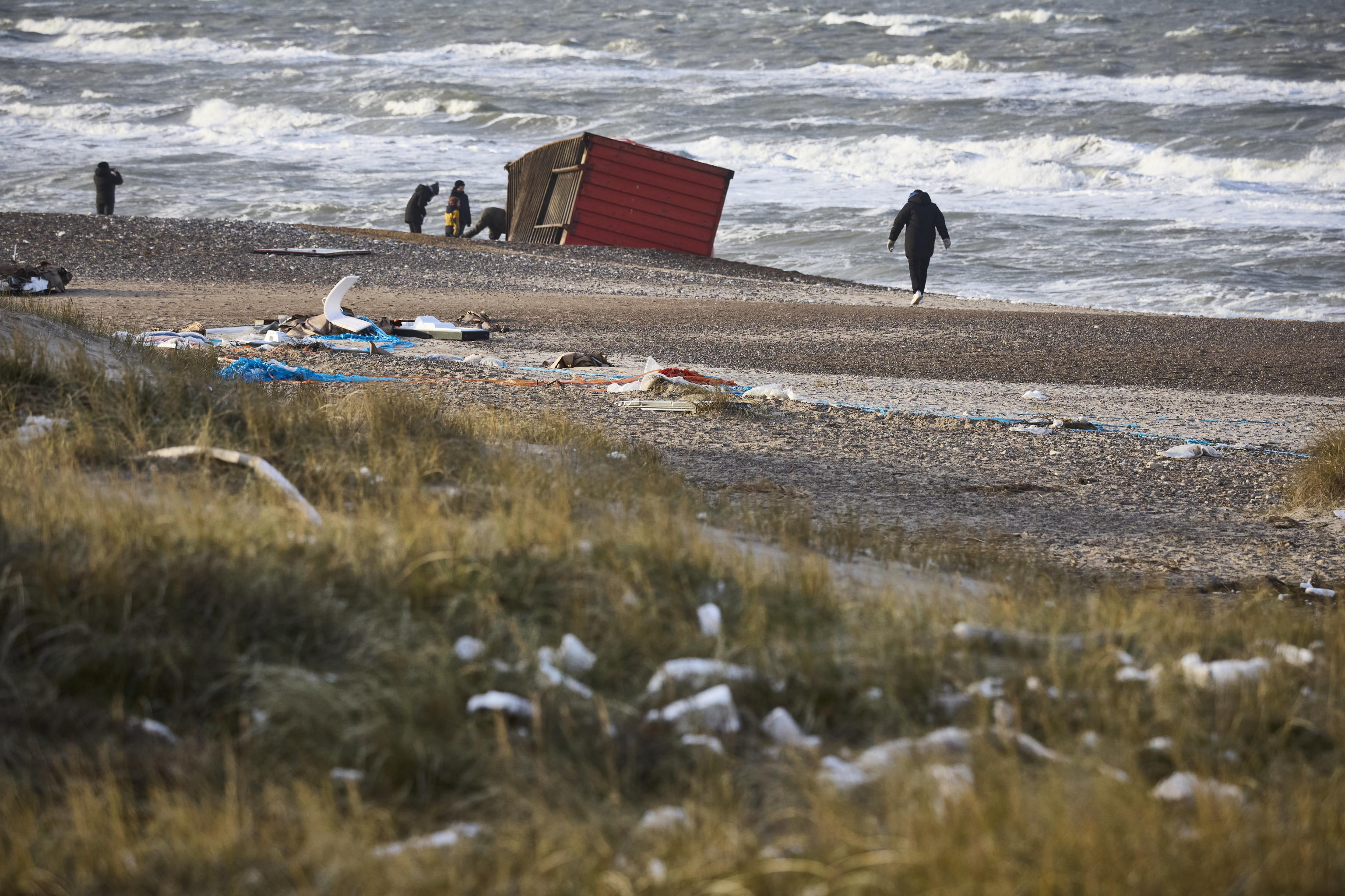 epa11044604 Locals inspect items from containers spillage  along the West coast at Tranum beach in North Jutland, Denmark, 26 December 2023. The contents of 46 lost containers from the ship Mayview Maersk wash ashore in North Jutland. The containers washed overboard during storm Pia.  EPA/Claus Bjoern Larsen  DENMARK OUT