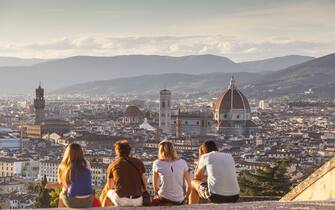 People watch the sunset from the steps of San Miniato al Monte over the city of Florence and the Basilica di Santa Maria del Fiore otherwise known as the Duomo.