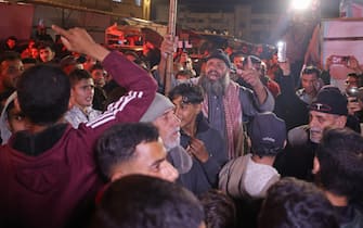People celebrate along a street in Khan Yunis in the southern Gaza Strip on January 15, 2025, amid the ongoing war in the Palestinian territory between Israel and Hamas. Thousands of Gazans celebrated on January 15 as news spread that a ceasefire and hostage release deal had been reached between Israel and Hamas, aimed at ending more than 15 months of war in the Palestinian territory. (Photo by BASHAR TALEB / AFP)