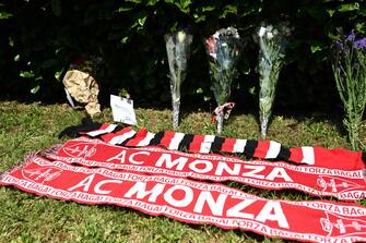 A photo shows flowers and AC Monza football club scarves layed in tribute outside Villa San Martino, the residence of Italian businessman and former prime minister Silvio Berlusconi, following his death, in Arcore, northern Italy, on June 12, 2023. Italy's former prime minister Silvio Berlusconi has died aged 86, his spokesman confirmed to AFP on June 12, 2023. The billionaire media mogul was admitted to a Milan hospital on June 9 for what aides said were pre-planned tests related to his leukemia. (Photo by Piero CRUCIATTI / AFP)