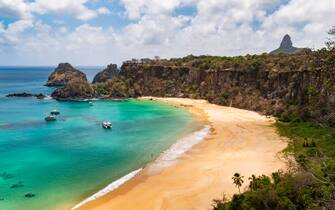 From the Golfinho-Sancho trail, it is possible to not only see the famous Sancho beach, and some of the slightly over 200 steps on the eastern side, but also see two of the more famous landmarks of Fernando de Noronha: O Pico, which is the highest point, and the Dois Irmaos ("two brothers"), which are just behind the eastern part of the Sancho beach.