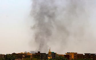 Smoke rises above buildings in war-torn Khartoum on May 21, 2023. Air strikes and artillery exchanges shook the Sudanese capital on May 21 and armed men ransacked the Qatari embassy as the country's warring generals kept up their struggle for control even as they agreed to a brief humanitarian pause. (Photo by AFP) (Photo by -/AFP via Getty Images)