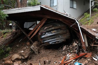epa11130066 A vehicle is buried in a collapsed garage and house that moved off its  foundation down a hill as a powerful atmospheric river storm hits Southern California in Beverly Hills, California USA, 05 February 2024. Los Angeles Mayor Karen Bass declared a state of emergency in the area as flooding and mudslides overwhelmed California.  EPA/ALLISON DINNER