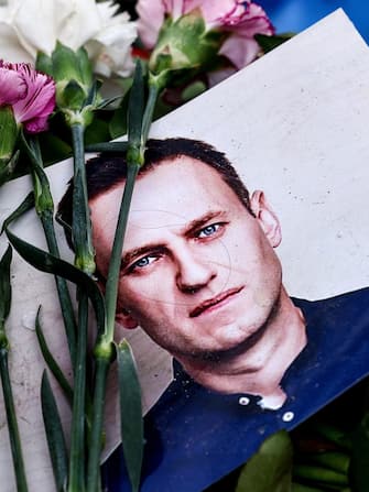 epaselect epa11191168 A portrait of late Russian opposition leader Alexei Navalny sits among floral tributes and a candle outside the Russian embassy in Berlin, Germany 01 March 2024. Outspoken Kremlin critic Navalny died aged 47 in an arctic penal colony on 16 February 2024 after being transferred there in 2023. The colony is considered to be one of the worldâ€™s harshest prisons.  EPA/FILIP SINGER