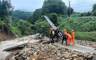 GYEONGSANGBUK-DO, SOUTH KOREA - JULY 15: (EDITORIAL USE ONLY) In this handout image provided by the Gyeingbuk Fire Servise Headquarters via Dong-A Daily, South Korean emergency workers searching for survivors after heavy rains in North Gyeongsang Province on July 15, 2023 in Gyeongsangbuk-do, South Korea. At least twelve people have died and ten have gone missing amid torrential rains that have flooded many parts of South Korea, forcing thousands of people to evacuate from homes. (Photo by Gyeingbuk Fire Servise Headquarters/Dong-A Daily via Getty Images)