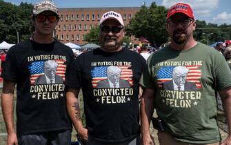 HARRISBURG, PENNSYLVANIA - JULY 31: Men pose in T-shirts as people line up to see Republican presidential nominee, former U.S. President Donald Trump speak on July 31, 2024 in Harrisburg, Pennsylvania. Trump is returning to Pennsylvania for the first time since the assassination attempt. Polls currently show a close race with Democratic presidential candidate, U.S. Vice President Kamala Harris.  (Photo by Stephanie Keith 100584/Getty Images)
