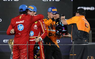 epa11765030 Second placed Scuderia Ferrari driver Carlos Sainz Jr. (L) of Spain, first placed McLaren driver Lando Norris (2-R) of Britain, McLaren Racing CEO Zak Brown (R) and third placed Scuderia Ferrari driver Charles Leclerc (2-L) of Monaco celebrate on the podium after the Formula One Abu Dhabi Grand Prix, at the Yas Marina Circuit racetrack in Abu Dhabi, United Arab Emirates, 08 December 2024.  EPA/ALI HAIDER