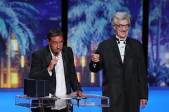 CANNES, FRANCE - MAY 25: Miguel Gomes (L) receives the 'Best Director' Award for 'Grand Tour' presented by Wim Wenders (R) during the Closing Ceremony at the 77th annual Cannes Film Festival at Palais des Festivals on May 25, 2024 in Cannes, France. (Photo by Victor Boyko/Getty Images)