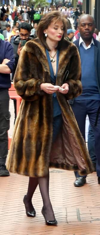 Sophie Turner shows off another new look whilst filming ITVX drama Joan in Birmingham, UK.

Sophie chanelled her inner Sopia Loren, wearing a vintage brown fur coat over a red 2 piece top and skirt set. She completed the look wearing an oversized pair of pear earrings.

In the latest television series, Sophie embodies the character of the infamous British jewel thief, Joan Hannington. This six-episode show is situated in 1980s London, narrating the extraordinary tale of a prominent figure within the criminal underbelly of the city.



Pictured: Sophie Turner

Ref: SPL9660033 110823 EXCLUSIVE

Picture by: UnBoxPHD / SplashNews.com



Splash News and Pictures

USA: 310-525-5808 
UK: 020 8126 1009

eamteam@shutterstock.com



World Rights