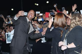 MEXICO CITY, MEXICO - MAY 23:  Actor Dwayne Johnson signs autographs to fans and takes selfies during the "San Andreas" Mexico City premiere at Cinepolis Acoxpa on May 23, 2015 in Mexico City, Mexico.  (Photo by Victor Chavez/WireImage)