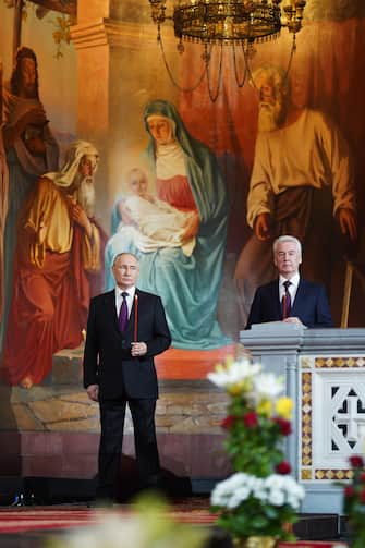 epa10575272 A handout photo made available by the Moscow and All Russia Partiarch Press Service shows Russian President Vladimir Putin (L) and Moscow's Mayor Sergei Sobyanin (R) attending the Orthodox Easter holiday service at the Christ the Saviour Cathedral in Moscow, Russia, 16 April 2023. Orthodox Christian believers mark the Holy Week of Easter in celebration of the crucifixion and resurrection of Jesus Christ. The Greek Orthodox world celebrates Easter Day according to the old Julian calendar.  EPA/OLEG VAROV / HANDOUT  HANDOUT EDITORIAL USE ONLY/NO SALES