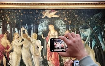 FLORENCE, ITALY - DECEMBER 30: Visitors view and photograph the painting Primavera (Spring)  by the 15th century Italian Renaissance artist Sandro Botticelli at the Uffizi Gallery on December 30, 2022 in Florence, the capital of Italyâ  s Tuscany region. The 16th century museum is famous for its collection of ancient sculptures and its paintings that date from the Middle Ages to the Modern period. (Photo by David Silverman/Getty Images)