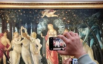 FLORENCE, ITALY - DECEMBER 30: Visitors view and photograph the painting Primavera (Spring)  by the 15th century Italian Renaissance artist Sandro Botticelli at the Uffizi Gallery on December 30, 2022 in Florence, the capital of Italyâ  s Tuscany region. The 16th century museum is famous for its collection of ancient sculptures and its paintings that date from the Middle Ages to the Modern period. (Photo by David Silverman/Getty Images)