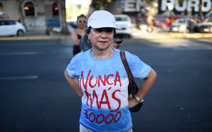 A woman takes part in a demonstration against Argentina's President Javier Milei and in support of the national strike in Santiago, on January 24, 2024. Argentine President Javier Milei faced the first national strike in just 45 days of government, against his draconian fiscal adjustment and his plan to reform more than a thousand laws and regulations that governed for decades. The largest Argentine union called the strike in rejection, in particular, of the changes by decree to the labor regime promoted by Milei, which limit the right to strike and affect the financing of unions. (Photo by Pablo Vera / AFP) (Photo by PABLO VERA/AFP via Getty Images)