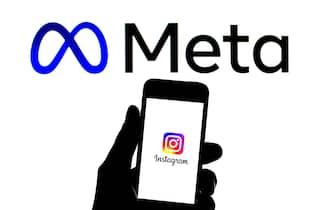 In this photo illustration an Instagram logo seen displayed on a smartphone with a Meta logo in the background. (Photo by Thiago Prudencio / SOPA Images/Sipa USA)