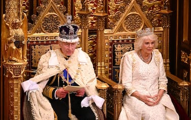 Britain's King Charles III, wearing the Imperial State Crown and the Robe of State, sits beside Britain's Queen Camilla, wearing the George IV State Diadem, as he reads the King's speech from The Sovereign's Throne in the House of Lords chamber, during the State Opening of Parliament, at the Houses of Parliament, in London, on November 7, 2023. (Photo by Leon Neal / POOL / AFP) (Photo by LEON NEAL/POOL/AFP via Getty Images)