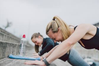 Girlfriends doing push-ups together and having fun