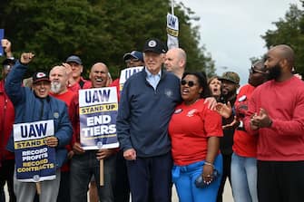 US President Joe Biden joins a picket line with members of the United Auto Workers (UAW) union at a General Motors Service Parts Operations plant in Belleville, Michigan, on September 26, 2023. Some 5,600 members of the UAW walked out of 38 US parts and distribution centers at General Motors and Stellantis at noon September 22, 2023, adding to last week's dramatic worker walkout. According to the White House, Biden is the first sitting president to join a picket line. (Photo by Jim WATSON / AFP) (Photo by JIM WATSON/AFP via Getty Images)