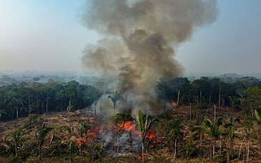 TOPSHOT - Smoke from illegal fires lit by farmers rises in Manaquiri, Amazonas state, on September 6, 2023. From September 2, 2023 to September 6, 2023, 2,500 forest fires in Amazon state alone were recorded by INPE, Brazil's National Institute for Space Research. (Photo by MICHAEL DANTAS / AFP) (Photo by MICHAEL DANTAS/AFP via Getty Images)