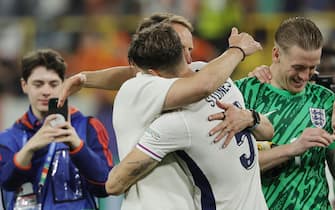 epa11471468 England head coach Gareth Southgate (L) hugs with player John Stones after winning the UEFA EURO 2024 semi-finals soccer match between Netherlands and England, in Dortmund, Germany, 10 July 2024.  EPA/RONALD WITTEK