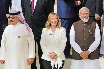India's Prime MIniater Narendra Modi (R), Italian Giorgia Meloni smile standing next to Bahrain's King Hamad bin Isa Al Khalifa as they arrive to pose with participating world leaders and delegates for a family photo during the COP28 United Nations climate summit in Dubai on December 1, 2023. World leaders take centre stage at UN climate talks in Dubai on December 1, under pressure to step up efforts to limit global warming as the Israel-Hamas conflict casts a shadow over the summit. (Photo by Giuseppe CACACE / AFP) (Photo by GIUSEPPE CACACE/AFP via Getty Images)