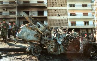 400042 11: Lebanese soldiers inspect the charred car of 45-year-old former Lebanese Christian warlord, Elie Hobeika, after he was killed in a bomb explosion January 24, 2002 near his home in Hazmeih, Lebanon, near Beirut. The bomb was planted in a parked car and was detonated by remote control as Hobeika drove past, killing Hobeika, his three bodyguards and wounding six others. Hobeika intended to testify as a key witness in a lawsuit pending in a Belgian court against Israeli Prime Minister Ariel Sharon. The lawsuit charges Sharon was responsible for the massacre of hundreds of civilians at Sabra and Shatila Palestinian refugee camps during the 1982 Israeli invasion of Lebanon. (Photo by Courtney Kealy/Getty Images)
