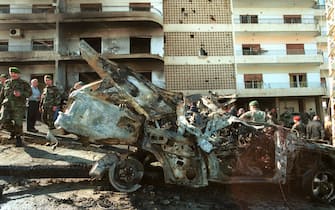 400042 11: Lebanese soldiers inspect the charred car of 45-year-old former Lebanese Christian warlord, Elie Hobeika, after he was killed in a bomb explosion January 24, 2002 near his home in Hazmeih, Lebanon, near Beirut. The bomb was planted in a parked car and was detonated by remote control as Hobeika drove past, killing Hobeika, his three bodyguards and wounding six others. Hobeika intended to testify as a key witness in a lawsuit pending in a Belgian court against Israeli Prime Minister Ariel Sharon. The lawsuit charges Sharon was responsible for the massacre of hundreds of civilians at Sabra and Shatila Palestinian refugee camps during the 1982 Israeli invasion of Lebanon. (Photo by Courtney Kealy/Getty Images)