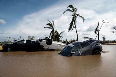 TOPSHOT - Cars lay partially under water in the aftermath of hurricane Otis at "Zona Diamante" in Acapulco, Guerrero State, Mexico, on October 27, 2023. Airlines began to evacuate tourists from Mexico's beachside city of Acapulco on Friday after a scale-topping Category 5 hurricane left a trail of destruction and at least 27 people dead, authorities said on October 27, 2023. (Photo by RODRIGO OROPEZA / AFP) (Photo by RODRIGO OROPEZA/AFP via Getty Images)