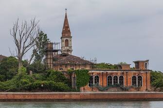 VENICE, ITALY  MAY 2: A general view of the 19th century Venetian geriatric hospital is seen on May 2, 2014 in Poveglia island in the Venice lagoon, Italy. Poveglia island, a 19th century Venetian geriatric hospital, has been put up for sale by Italy's public property agency. A resident's association "Poveglia per tutti" (Poveglia for all) is trying to buy it and give it back to the community. (Photo By Marco Di Lauro/Getty Images)