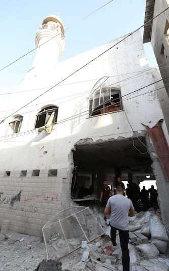 epa10932248 Palestinians inspect the damages following an Israeli airstrike at Al-Ansar Mosque at Jenin refugee camp on 22 October 2023. At least two people were killed in an early morning Israeli forces airstrike on Al Ansar mosque in Jenin, according to Palestinian Health Ministry. The Israeli Defense Forces said the airstrike was targeting the Hamas and Islamic Jihad terrorist compound in the Al-Ansar Mosque in Jenin.  EPA/ALAA BADARNEH