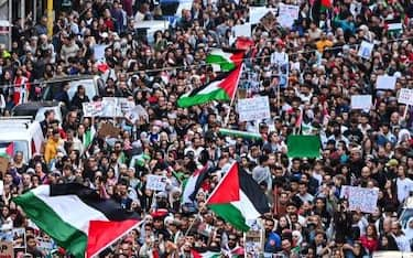 Protesters wave flags as they march during a demonstration in support of Palestinians in Milan, on October 21, 2023. Thousands of people, both Israeli and Palestinians have died since October 7, 2023, after Palestinian Hamas militants based in the Gaza Strip, entered southern Israel in a surprise attack leading Israel to declare war on Hamas in Gaza the following day. (Photo by Piero CRUCIATTI / AFP) (Photo by PIERO CRUCIATTI/AFP via Getty Images)