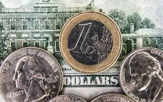 Una banconota da un dollaro e delle monete da un euro