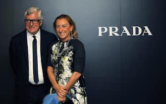 epa02769929 Italian Prada S.p.A. Chief Exicitive Officer Patrizio Bertelli (L) poses with his wife Italian designer and entrepreneur Miuccia Prada during the investors luncheon presentation in Hong Kong, China, 07 June 2011. Prada S.p.A. the Italian luxury brand is reportedly set to raise as much as 2.6 billion US dollars after setting the price range for its highly anticipated offering in Hong Kong on 24 June, media reported.  EPA/YM YIK