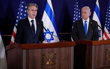Israeli Prime Minister Benjamin Netanyahu (R) looks on as US Secretary of State Antony Blinken gives statements to the media inside The Kirya, which houses the Israeli Defence Ministry, after their meeting in Tel Aviv on October 12, 2023. Blinken arrived in a show of solidarity after Hamas's surprise weekend onslaught in Israel, an AFP correspondent travelling with him reported. He is expected to visit Israeli Prime Minister Benjamin Netanyahu as Washington closes ranks with its ally that has launched a withering air campaign against Hamas militants in the Gaza Strip. (Photo by Jacquelyn Martin / POOL / AFP) (Photo by JACQUELYN MARTIN/POOL/AFP via Getty Images)