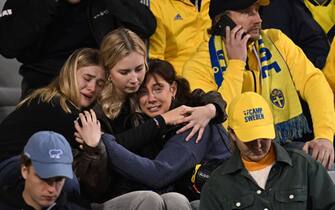 TOPSHOT - Swedish supporters react as they wait in the stand during the Euro 2024 qualifying football match between Belgium and Sweden at the King Baudouin Stadium in Brussels on October 16, 2023, after an 'attack' that targeted Swedish citizens in a street of Brussels. Belgian federal prosecutor leading on terrorism cases launched an investigation into an attack that left two dead in Brussels on October 16, 2023 evening, a spokesman told AFP. Belgium PM slams Brussels 'attack' targeting Swedish citizens. (Photo by JOHN THYS / AFP) (Photo by JOHN THYS/AFP via Getty Images)