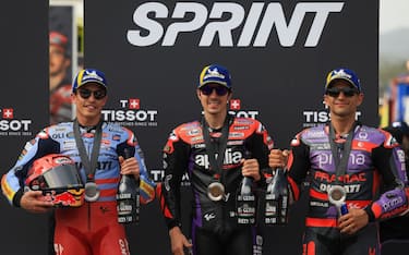Winner Aprilia Spanish rider Maverick Vinales (C), second-placed Ducati Spanish rider Marc Marquez and third-placed Ducati Spanish rider Jorge Martin pose for pictures after the MotoGP sprint race of the Portuguese Grand Prix at the Algarve International Circuit in Portimao on March 23, 2024. (Photo by PATRICIA DE MELO MOREIRA / AFP) (Photo by PATRICIA DE MELO MOREIRA/AFP via Getty Images)