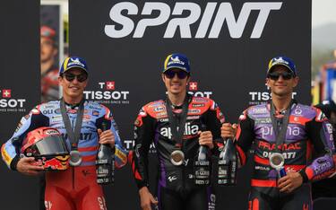 Winner Aprilia Spanish rider Maverick Vinales (C), second-placed Ducati Spanish rider Marc Marquez and third-placed Ducati Spanish rider Jorge Martin pose for pictures after the MotoGP sprint race of the Portuguese Grand Prix at the Algarve International Circuit in Portimao on March 23, 2024. (Photo by PATRICIA DE MELO MOREIRA / AFP) (Photo by PATRICIA DE MELO MOREIRA/AFP via Getty Images)