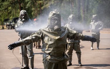 20 July 2022, Brandenburg, Neuenhagen: During a visit by Foreign Minister Baerbock to the Barnim barracks, a decontamination exercise is shown by the NBC defense regiment of the Bundeswehr. Baerbock visits the NBC defense regiment of the Bundeswehr. NBC are nuclear, biological and chemical warfare agents. Photo: Christophe Gateau/dpa (Photo by Christophe Gateau/picture alliance via Getty Images)