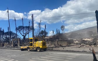 A utility vehicule is parked by destroyed buildings and homes pictured in the aftermath of a wildfire in Lahaina, western Maui, Hawaii on August 11, 2023. A wildfire that left Lahaina in charred ruins has killed at least 55 people, authorities said on August 10, making it one of the deadliest disasters in the US state's history. Brushfires on Maui, fueled by high winds from Hurricane Dora passing to the south of Hawaii, broke out August 8 and rapidly engulfed Lahaina. (Photo by Paula RAMON / AFP) / "The erroneous mention[s] appearing in the metadata of this photo by Paula RAMON has been modified in AFP systems in the following manner: [August 11] instead of [August 10]. Please immediately remove the erroneous mention[s] from all your online services and delete it (them) from your servers. If you have been authorized by AFP to distribute it (them) to third parties, please ensure that the same actions are carried out by them. Failure to promptly comply with these instructions will entail liability on your part for any continued or post notification usage. Therefore we thank you very much for all your attention and prompt action. We are sorry for the inconvenience this notification may cause and remain at your disposal for any further information you may require." (Photo by PAULA RAMON/AFP via Getty Images)