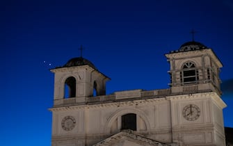 Planets Jupiter and Venus in conjunction are seen after sunset behind San Massimo church in LAquila, Italy, on march 1st, 2023. Planets seem to be very close (less than a degree away from each other). Moons (satellites) of Jupiter are visible even with a telephoto lens. (Photo by Lorenzo Di Cola/NurPhoto via Getty Images)