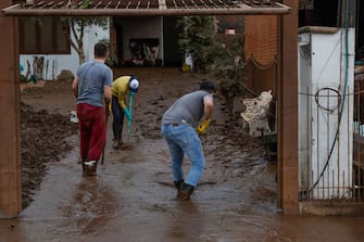 MUÃ UM, BRAZIL - SEPTEMBER 7: Residents remove mud from their home caused by flooding from the tropical cyclone on September 7, 2023 in MuÃ§um, Brazil. An extratropical cyclone hits the southern region of Brazil flooding more than 60 cities. According to local authorities, death toll nears 40 and thousands are displaced. (Photo by Marcelo Oliveira/Getty Images)