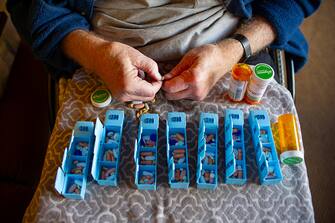Disabled person with Multiple Sclerosis hand sorting prescription pills. (Photo by: Kurt Wittman/UCG/Universal Images Group via Getty Images)