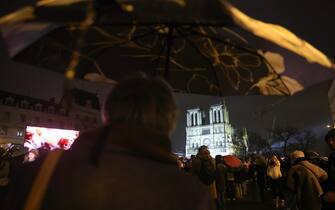 epa11762662 People gather ahead of the reopening ceremony of the Notre Dame de Paris Cathedral in Paris, France, 07 December 2024. The Notre Dame de Paris Cathedral reopens on 07 December after nearly six years of renovation work following its destruction by a fire on 15 April 2019.  EPA/TERESA SUAREZ
