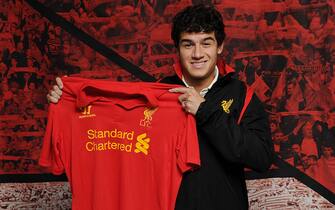 LIVERPOOL, ENGLAND - JANUARY 30:  (THE SUN OUT, THE SUN ON SUNDAY OUT) (EXCLUSIVE COVERAGE) (PREMIUM PRICING APPLIES - MINIMUM PRINT FEE OF GBP 150, ONLINE FEE OF GBP 75 OR LOCAL EQUVALENTS)  Philippe Coutinho poses with the club shirt after signing for Liverpool FC on January 30, 2013 in Liverpool, England.  (Photo by Andrew Powell/Liverpool FC via Getty Images)