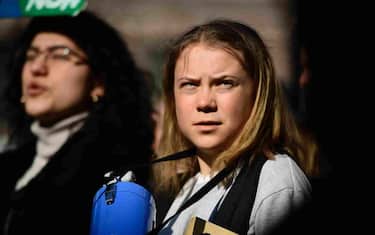 epa09848732 Swedish climate activist Greta Thunberg (C) along with other activists and students takes part in a Fridays For Future school strike for climate and social justice in Stockholm, Sweden, 25 March 2022. The 10th global strike of Fridays for Future takes place under the motto '#PeopleNotProfit'.  EPA/PAUL WENNERHOLM SWEDEN OUT