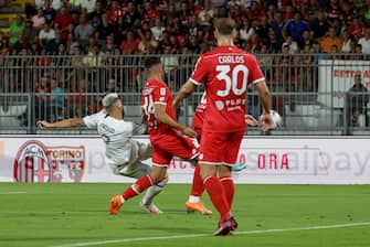 AC Milan's forward Oliver Giroud in action against AC Monza's defender Andrea Carboni during the  Silvio Berlusconi  Trophy soccer match between AC Monza and AC Milan at U-Power Stadium in Monza, Italy, 8 August 2023. ANSA /  ROBERTO BREGANI