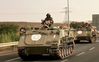Israeli soliders ride in their armoured vehicles towards the border with the Gaza Strip on October 16, 2023, amid the ongoing battles between Israel and the Palestinian group Hamas. Thousands of people, both Israeli and Palestinians have died since October 7, 2023, after Palestinian Hamas militants based in the Gaza Strip, entered southern Israel in a surprise attack leading Israel to declare war on Hamas in Gaza on October 8. (Photo by Menahem KAHANA / AFP) (Photo by MENAHEM KAHANA/AFP via Getty Images)