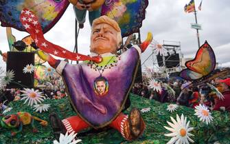 VIAREGGIO, ITALY - FEBRUARY 9: The detail of a papier-mache mask representing American President Donald Trump with a sticker of Elon Musk on it, moves through the streets of Viareggio during the traditional Carnival of Viareggio parade on February 9, 2025 in Viareggio, Italy. The Carnival of Viareggio is considered one of the most important carnivals in Italy and is characterised by its giant papier-mache floats depicting caricatures of popular characters, politicians and fictional creations. Said to be one of the most important carnivals in Italy and Europe, the floats are renowned to be the biggest in the world.(Photo by Laura Lezza/Getty Images)